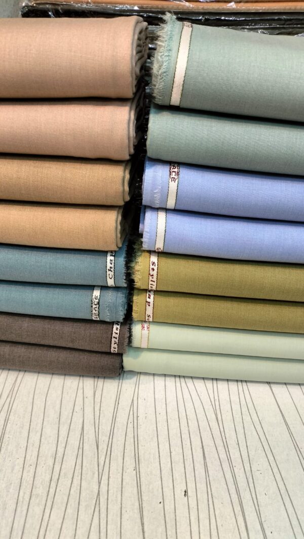 Eight distinct colors of authentic grace fabrics wash and wear steel blue unstitched rolls arranged in two rows showing brand edge labeling